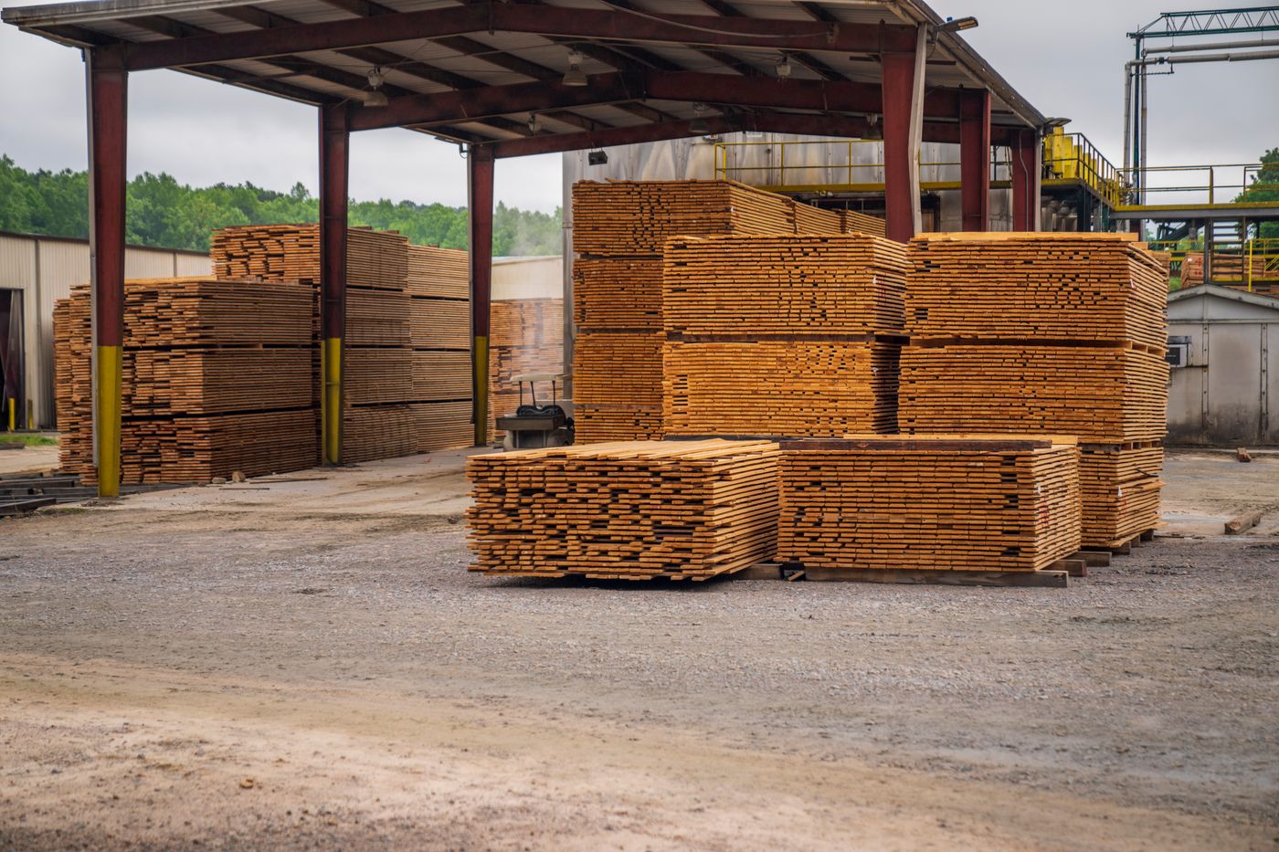 Stacked timber planks at an outdoor lumber yard