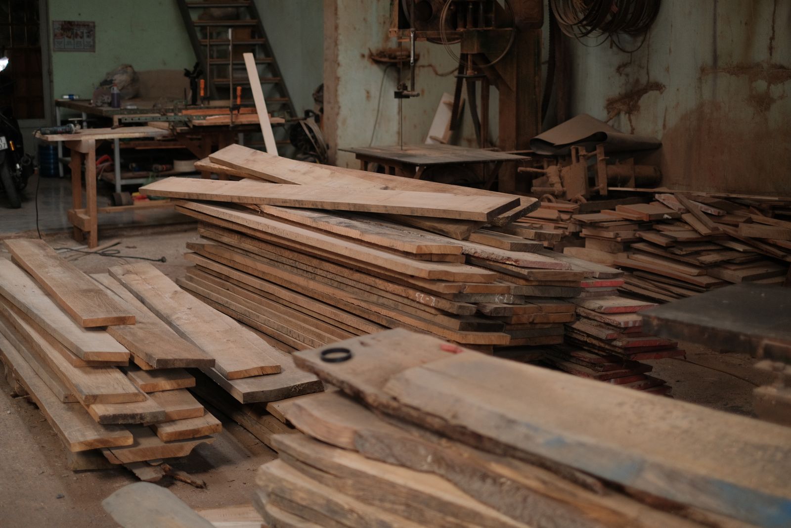 Wood planks stacked in a pallet fabrication workshop